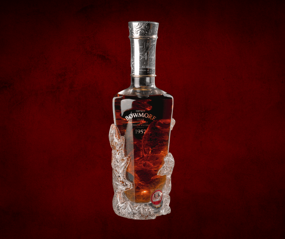 A bottle of Bowmore 1957 Scotch whisky with dark amber liquid, encased in an ornate crystal base, exudes luxury against a deep red textured background.