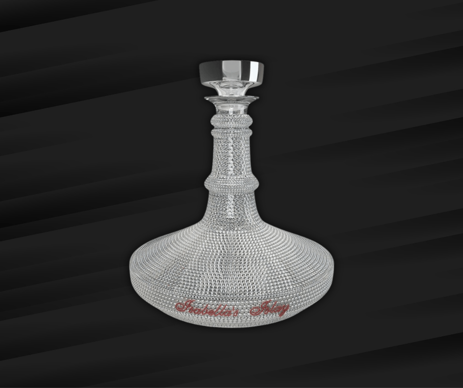 A crystal decanter encrusted with diamonds, featuring a rounded base and tall neck, set against a dark, gradient background. The decanter base has red script text.